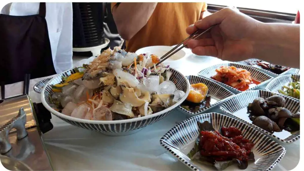 a person holding chopsticks over a bowl of food