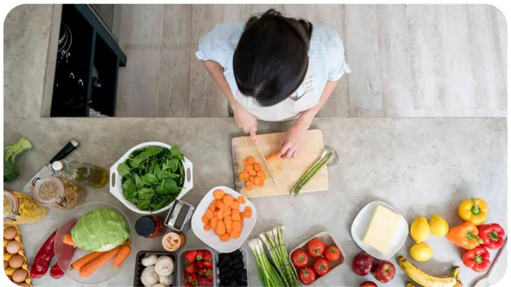 top view of a person cutting vegetables on a kitchen counter