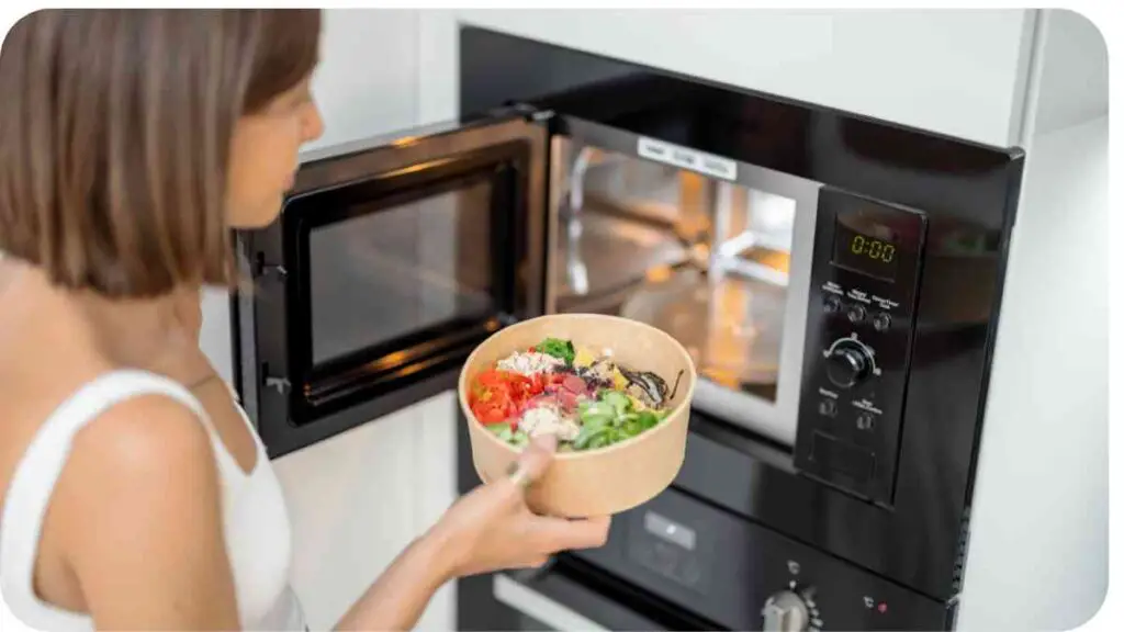 a person holding a bowl of food in front of an oven